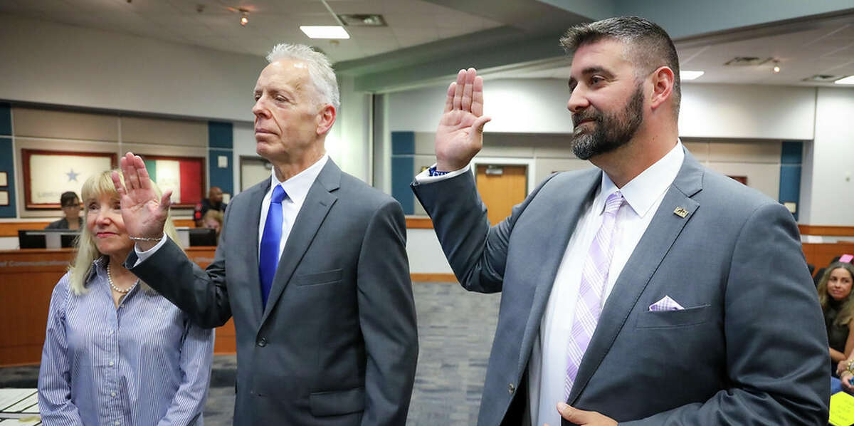 Victor Perez (left) and Lance Redmon are sworn in as Katy ISD board of trustees on May 13, 2022.