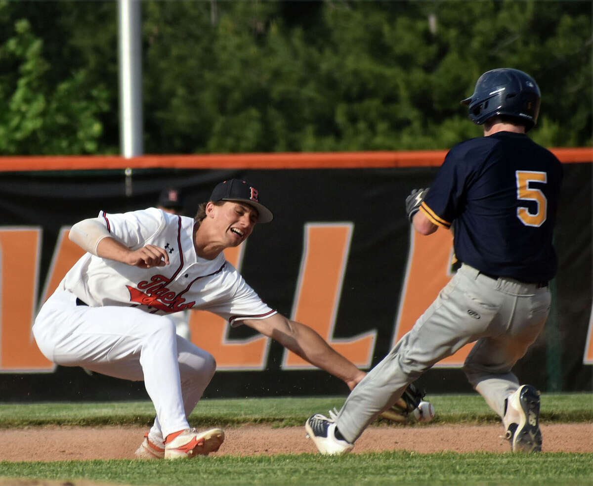 Edwardsville's Kayden Jennings (left) reaches for a throw on a stolen base by O’Fallon’s Haidyn McGill on Tuesday at Tom Pile Field in Edwardsville.