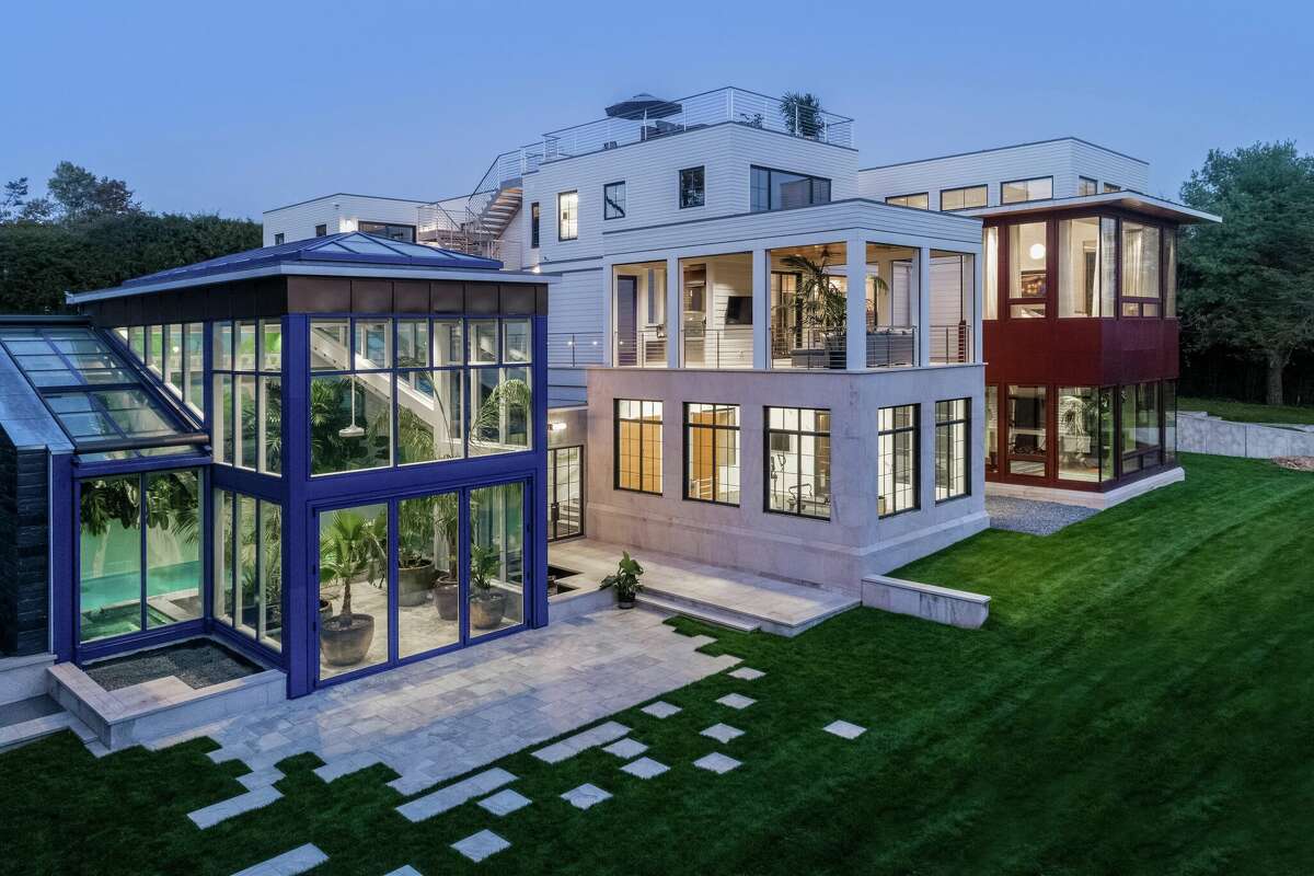 The home on 11 Bluewater Hill in Westport, Conn. has a glass conservatory, a floating staircase and a free-form gym with 10-foot windows.