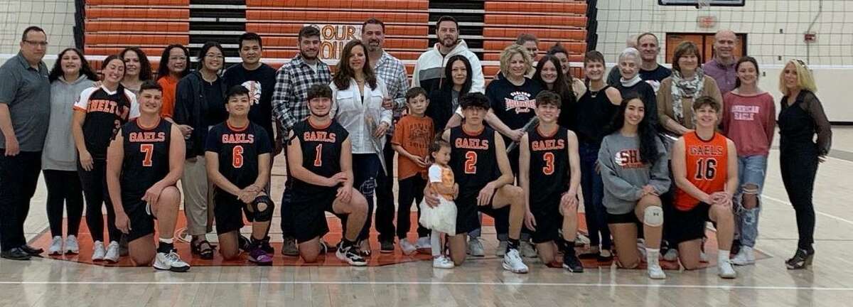 Shelton boys' volleyball coach LeAnne Bianchine and family members celebrate the contribution of senior members of the team.
