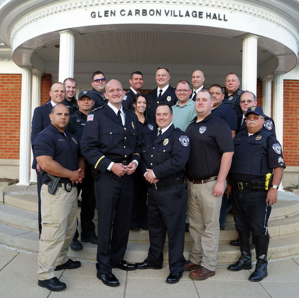 Glen Carbon Police Chief Todd Link, back row, center, and his officers in a pre-COVID pose on the steps of village hall. Link wants to add 3 more officers to his ranks. 