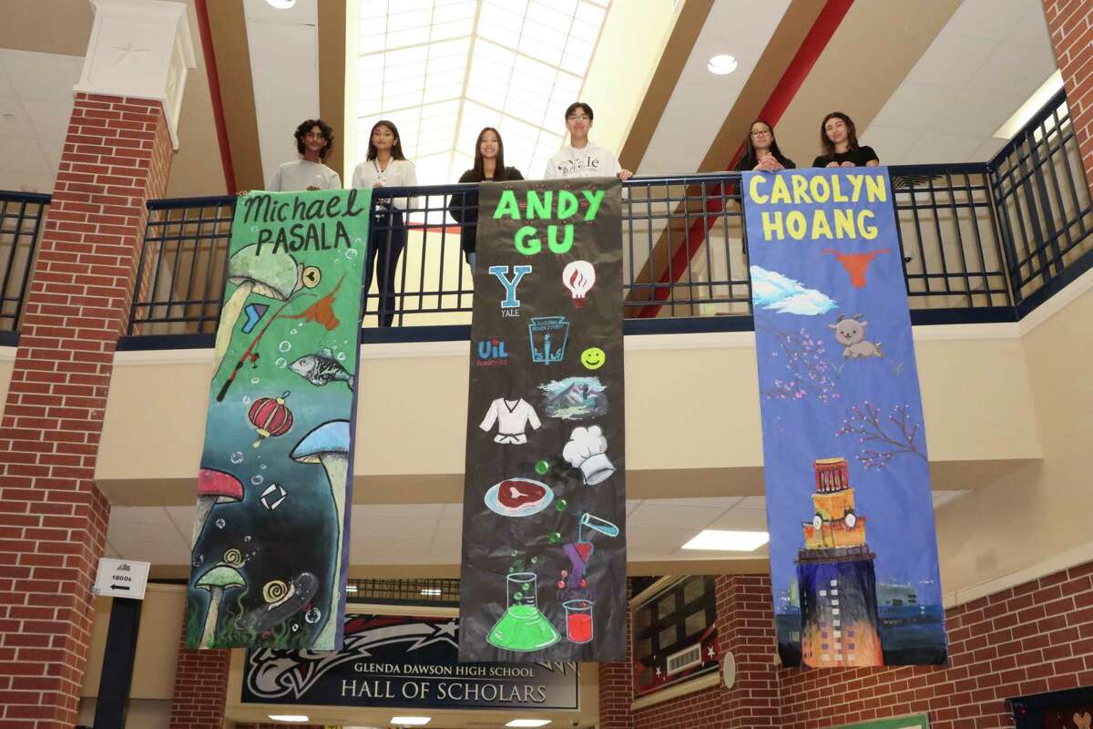 To celebrate the Top 20 graduating seniors at Dawson High school, a member of the student council paired with each of the 20 to make a banner celebrating that senior. From the left are: Top 20 senior Michael Pasala and banner artist Aruna Muthupillai, banner artist Gracin Nguyen and top student Andy Gu, and top student Carolyn Hoang and banner artist Kamille Hernandez.