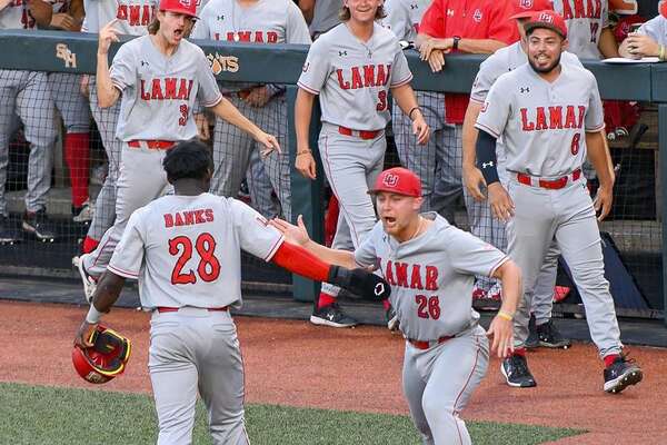 Kirkland Banks (28) and Jack Dallas (26) celebrate during a Lamar win over Sam Houston. The Cardinals will try to catch the Bearkats in the standings this weekend. 