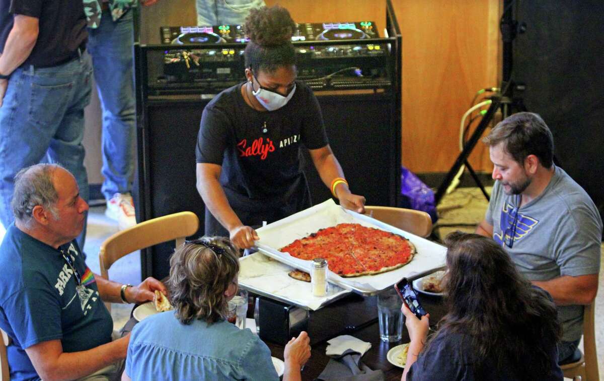 A Sally’s Apizza employee works the tables in October 2021 at the chain’s newest location in Stamford, Conn. While Connecticut logged record job quits that month, but the state’s employment count has increased six straight months despite continuing escalated levels of job quits.