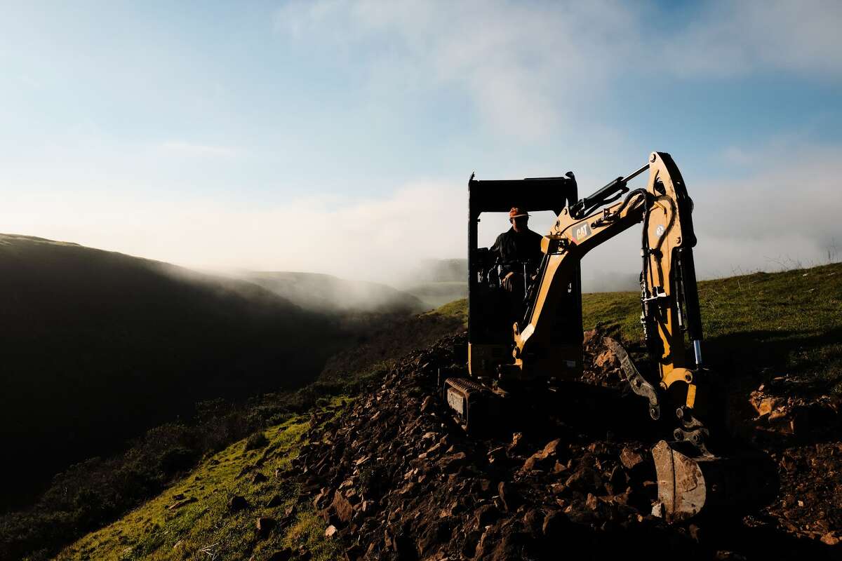 A Cat 301.7 CR Mini Excavator plowing the terrain in the Cotoni-Coast Dairies National Monument.