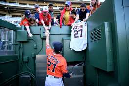 Houston Astros' Jose Altuve signs autographs for fans after a baseball game against the Washington Nationals, Sunday, May 15, 2022, in Washington.( AP Photo/Nick Wass)