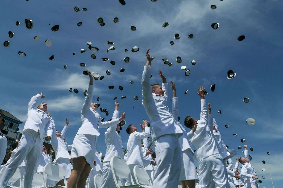 U.S. Coast Guard Academy cadets throw their hats in the air at the conclusion of the 141st Commencement Exercises at the U.S. Coast Guard Academy on Wednesday, May 18, 2022 in New London, Conn. Vice President Kamala Harris delivered the keynote address. (AP Photo/Stephen Dunn)