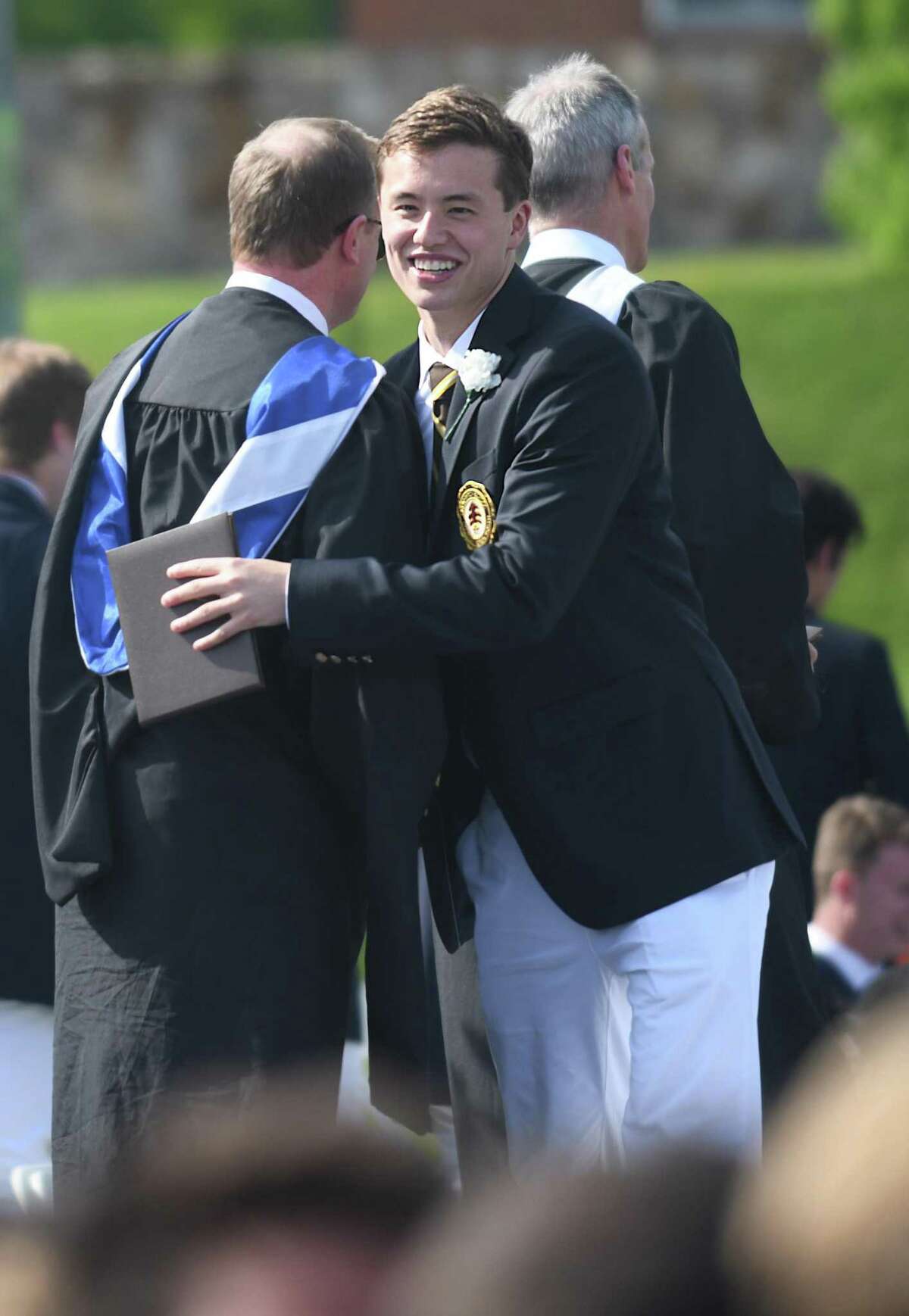 Jack Moore receives his diploma at the Brunswick School 120th Commencement at Brunwick's Lower School Campus in Greenwich, Conn. Wednesday, May 18, 2022.