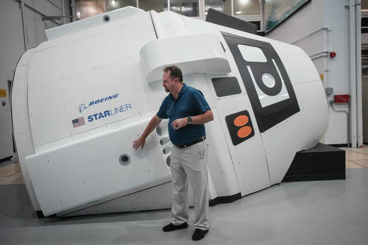 Steven Siceloff, of Boeing, talks about a simulator for the Boeing CST-100 Starliner spacecraft at NASA’s Johnson Space Center Tuesday, May 17, 2022 in Houston. This spacecraft is expected to dock with the International Space Station this week as part of an uncrewed test flight.