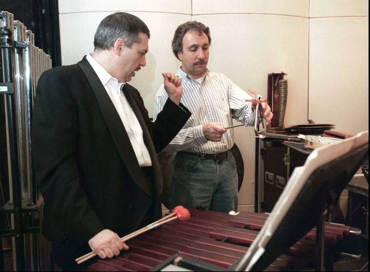 Ian Finkel of New York City instructs Jerry Zezima on the finer points of triangle playing during a rehearsal of the Stamford Symphony’s gala salute to George Gershwin at the Palace Theatre in 1997.