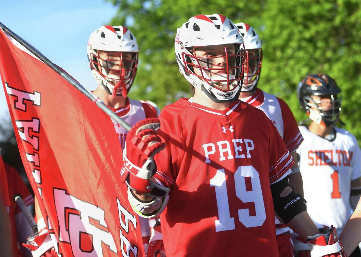 Fairfield Prep lacrosse players, teammates of deceased Fairfield Prep lacrosse player James McGrath, a Shelton resident, take the field for the Prep-Shelton lacrosse game in Shelton, Conn. on Wednesday, May 18, 2022.