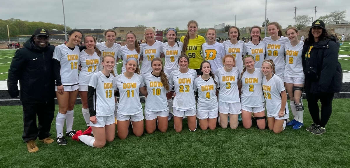 Dow High's girls' soccer team poses after beating Grand Blanc 1-0 to earn the Chargers' first Saginaw Valley League championship since 2014 on Wednesday, May 18, 2022.