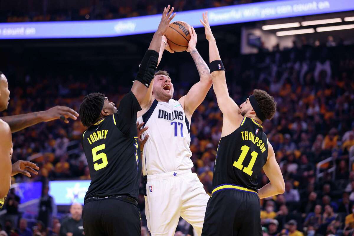 Dallas Mavericks’ Luka Doncic is double teamed by Kevon Looney and Klay Thompson in 1st quarter of Game 1 of NBA Western Conference Finals at Chase Center in San Francisco, Calif., on Wednesday, May 18, 2022.