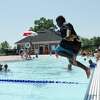 Greenwich's Noah Bates, 8, jumps in the water at the Greenwich Pool in Byram Park in Greenwich, Conn. Tuesday, June 29, 2021.