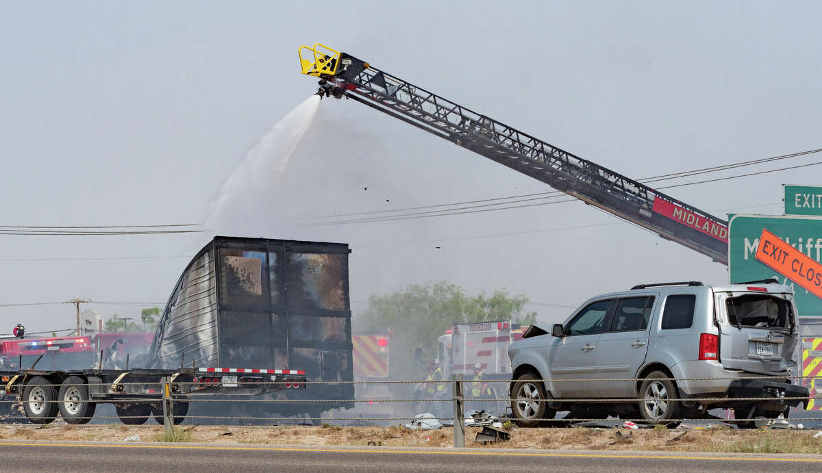 Midland fire officials continue to put water on a semi-truck that burned to the ground 05/19/2022 just east of Cottonflat Road on I-20. Westbound I-20 traffic was backed up as officials worked to put out the fire and clear multiple vehicles involved in the accident. Tim Fischer/Reporter-Telegram