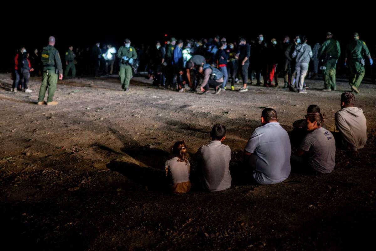ROMA, TEXAS - MAY 05: A migrant family sits after being processed on May 05, 2022 in Roma, Texas. Texas Gov. Greg Abbott's "Lone Star Operation" directed approximately 10,000 members of the National Guard to assist law enforcement with patrol and border apprehensions. The operation is expected to receive another $500 million to further secure the southern border. Towns along the border continue making preparations as Title 42 is scheduled to end on May 23rd. (Photo by Brandon Bell/Getty Images)