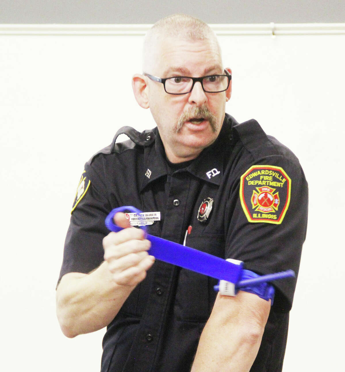 Edwardsville Firefighter/Paramedic Derek Huber demonstrates how to put on a tourniquet during a "Stop the Bleed" class Thursday at the Edwardsville Public Safety Building. May is "Stop the Bleed Month." The program is designed to teach people how to deal with excessive bleeding, which is a major cause of preventable death.