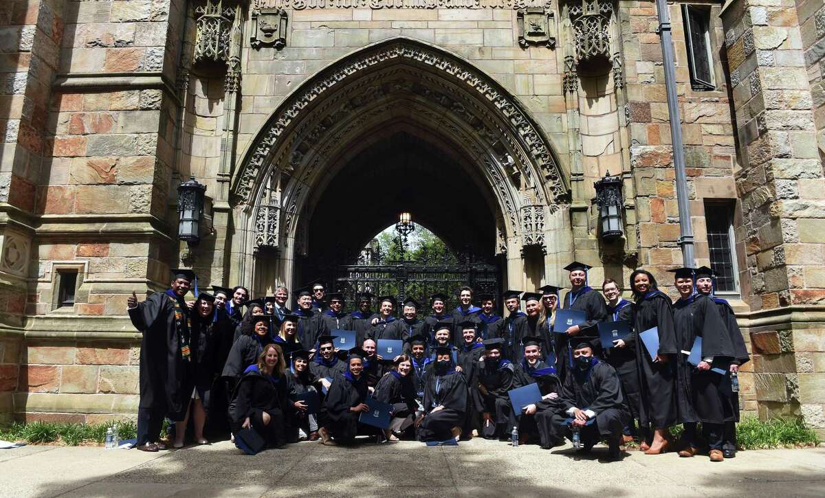 Yale School of Management graduates pose for a photograph after commencement exercises on Yale University's Old Campus in New Haven on May 24, 2021.