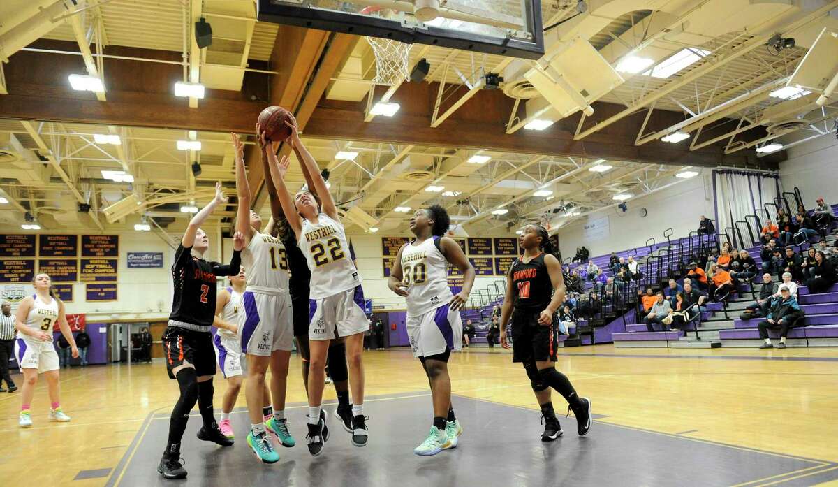 Westhill's Jadelun Carty and Audra Hansen (22) battle for a rebound against Stamford in a girls basketball game of the MLK Classic Basketball Tournament at Westhill High School in Stamford, Conn. on Feb. 1, 2020. Stamford defeated Westhill 49-29.