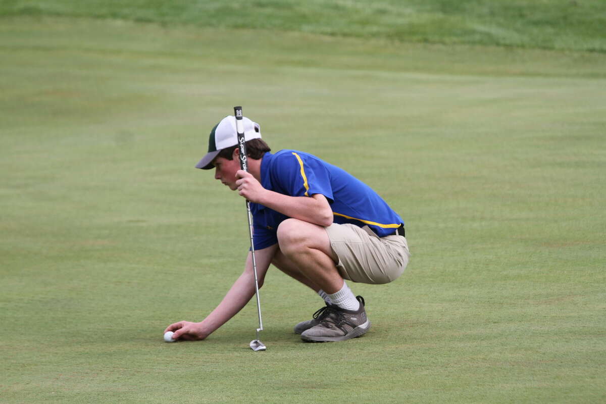 Peyton Clouse lines up his putt on Thursday afternoon. 
