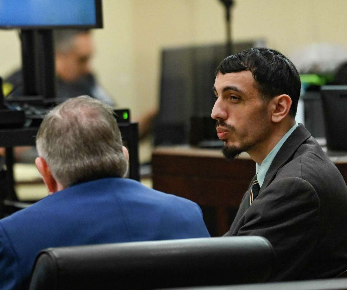 Eduardo Torres, who is accused, along with his brother, Leonard Torres, of robbing and shooting Nathan Valdez, 21, on South Presa Street on Oct. 24, 2016, speaks with his lawyer, John Economidy, at his capital murder trial in 399th District Court on Thursday.