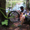 Nikk and Gillian Scott take a lunch break by a beaver pond at Tupelo Community Forest.