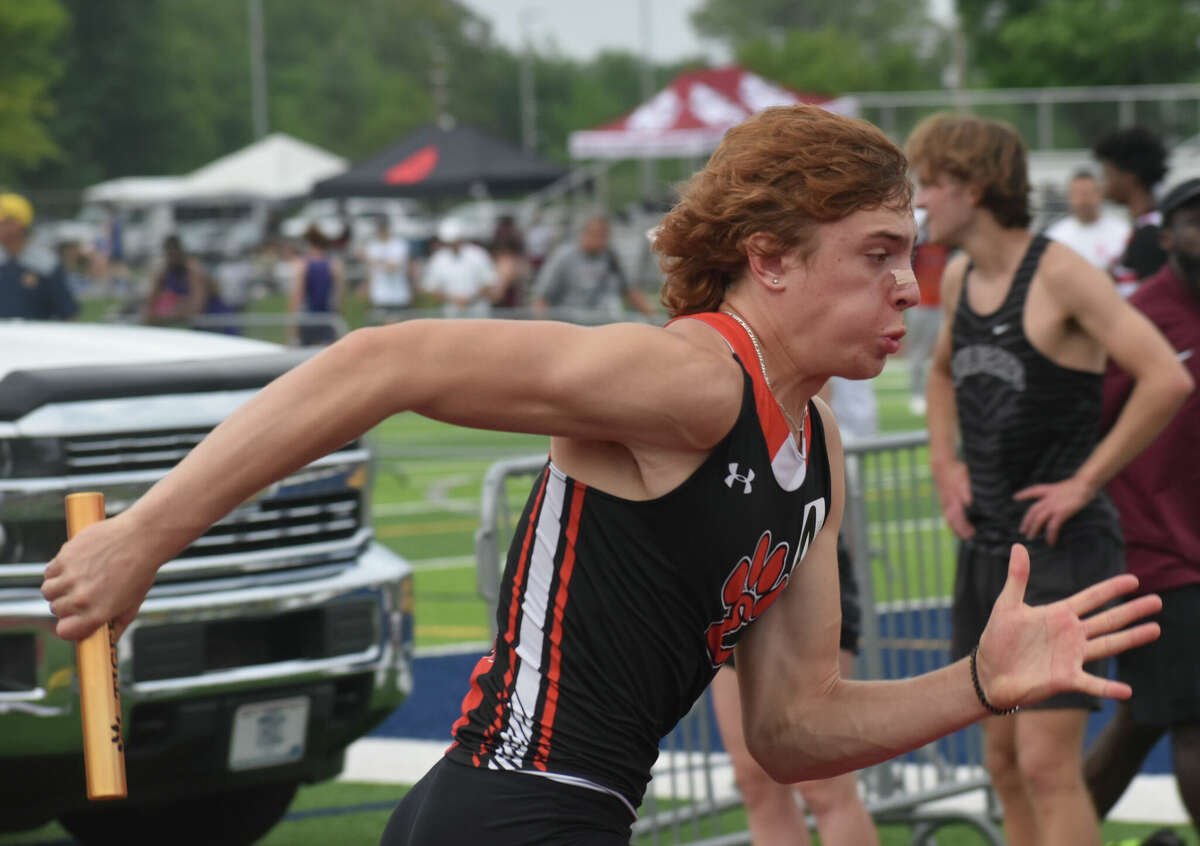 Edwardsville's Clayton Lakatos competes in the 800-meter relay during the Class 3A O'Fallon Sectional on Thursday in O'Fallon.