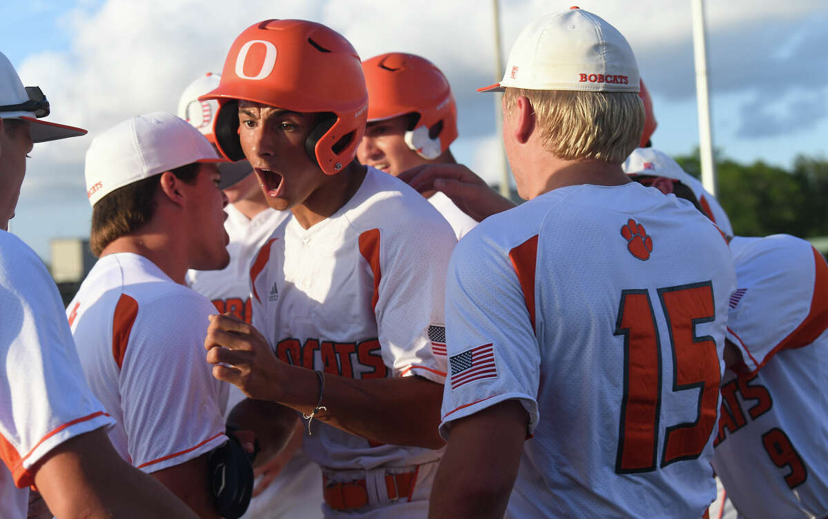 Orangefield's Kameryn Henderson celebrates with teammates after bringing in the first run during their regional quarterfinal against Livingston at Port Neches-Groves Thursday. Photo made Thursday, May 19, 2022. Kim Brent/The Enterprise