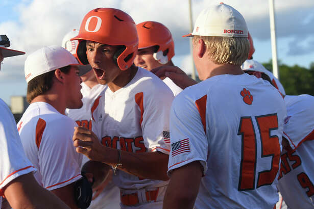Orangefield's Kameryn Henderson celebrates with teammates after bringing in the first run during their regional quarterfinal against Livingston at Port Neches-Groves Thursday. Photo made Thursday, May 19, 2022. Kim Brent/The Enterprise