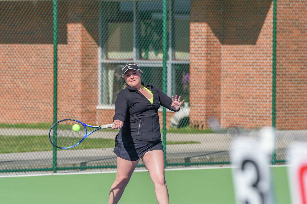 Dow High's Claire Earley returns a shot during an April 21, 2022 match against Midland High. Earley won the No. 3 singles title at Thursday's Division 1 regional tournament.