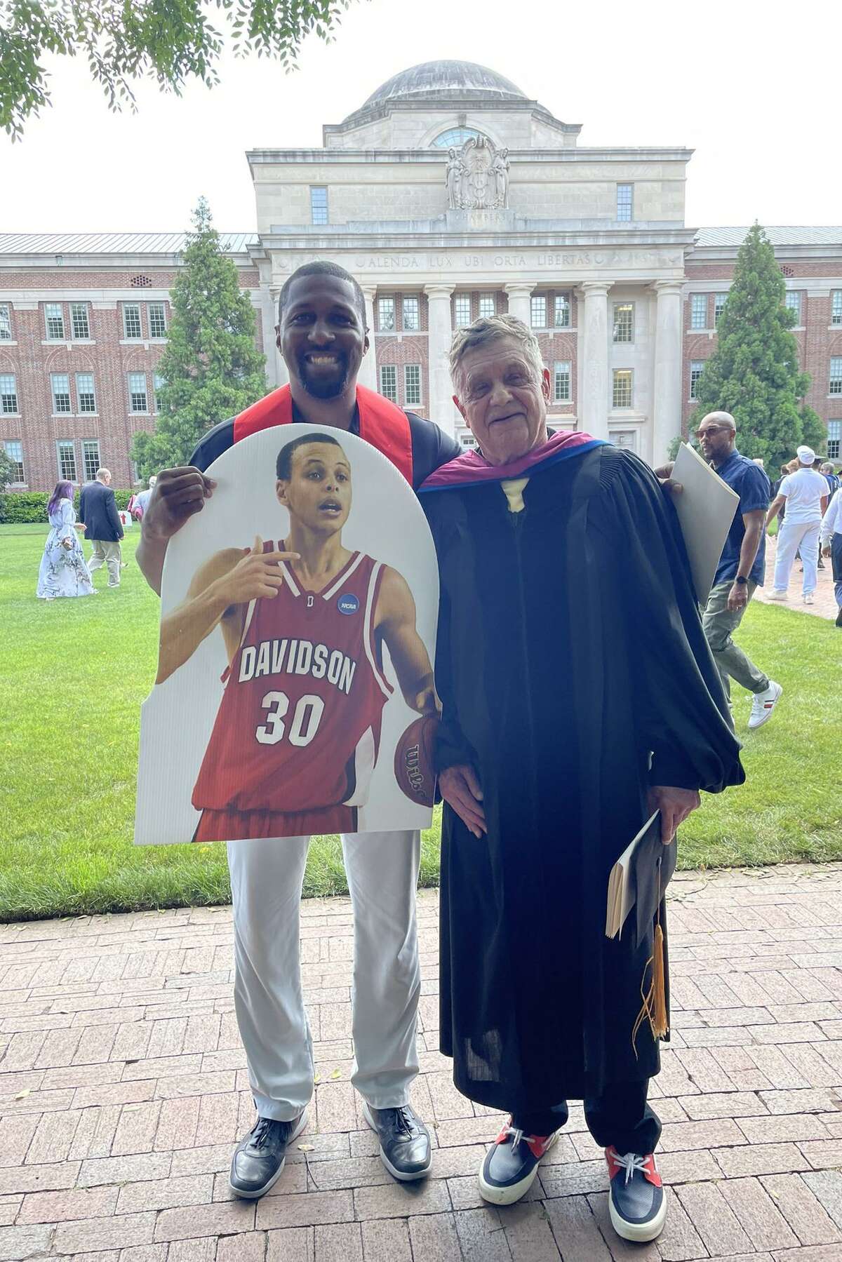 Director of Athletics Chris Clunie and Dr. Clark Ross with the Stephen Curry fathead at the Davidson commencement.