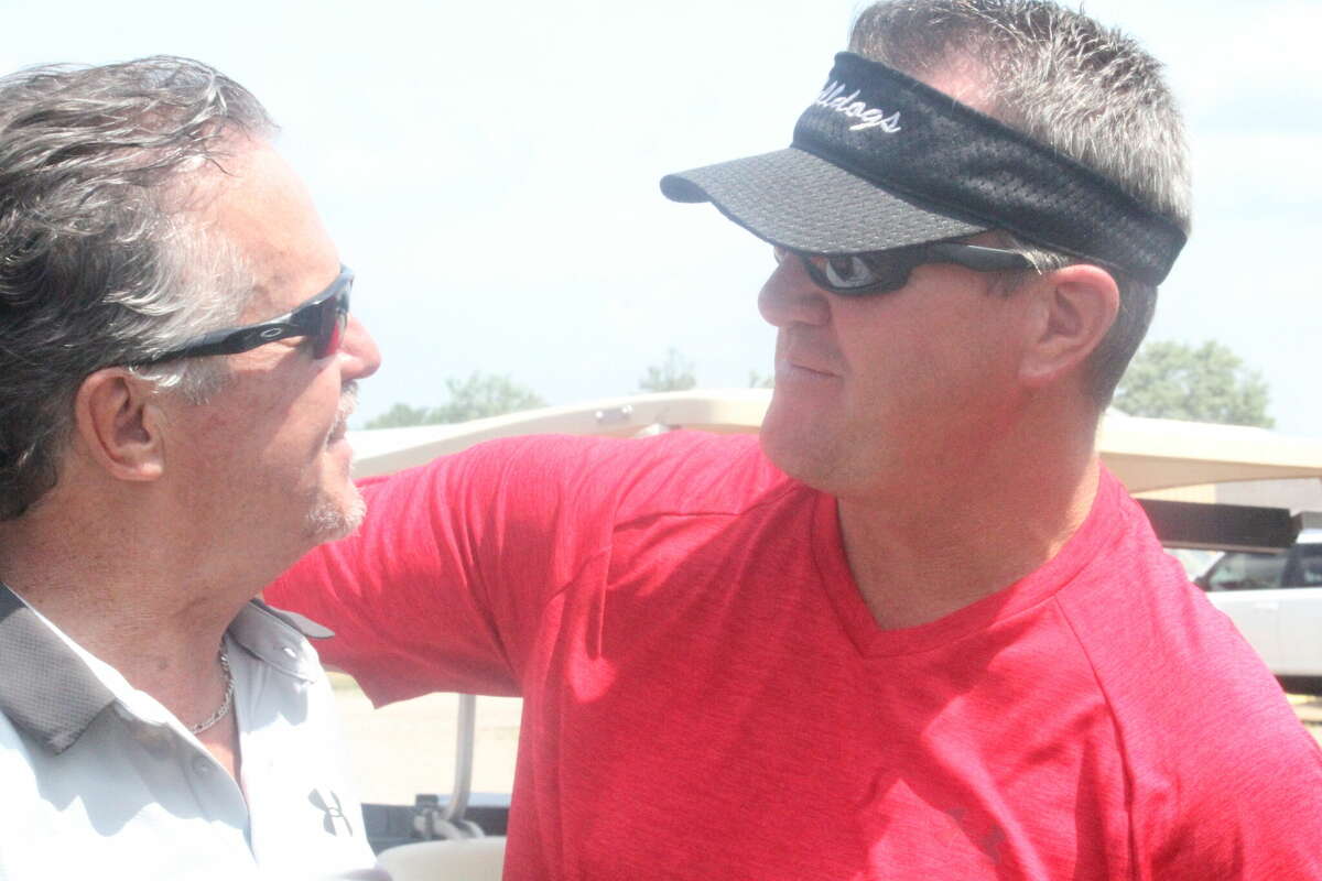 Former Ferris football coach Jeff Pierce (left) and former quarterback Bill Love chat with each other at the 2020 FSU football golf outing at Clear Lake Golf Club.