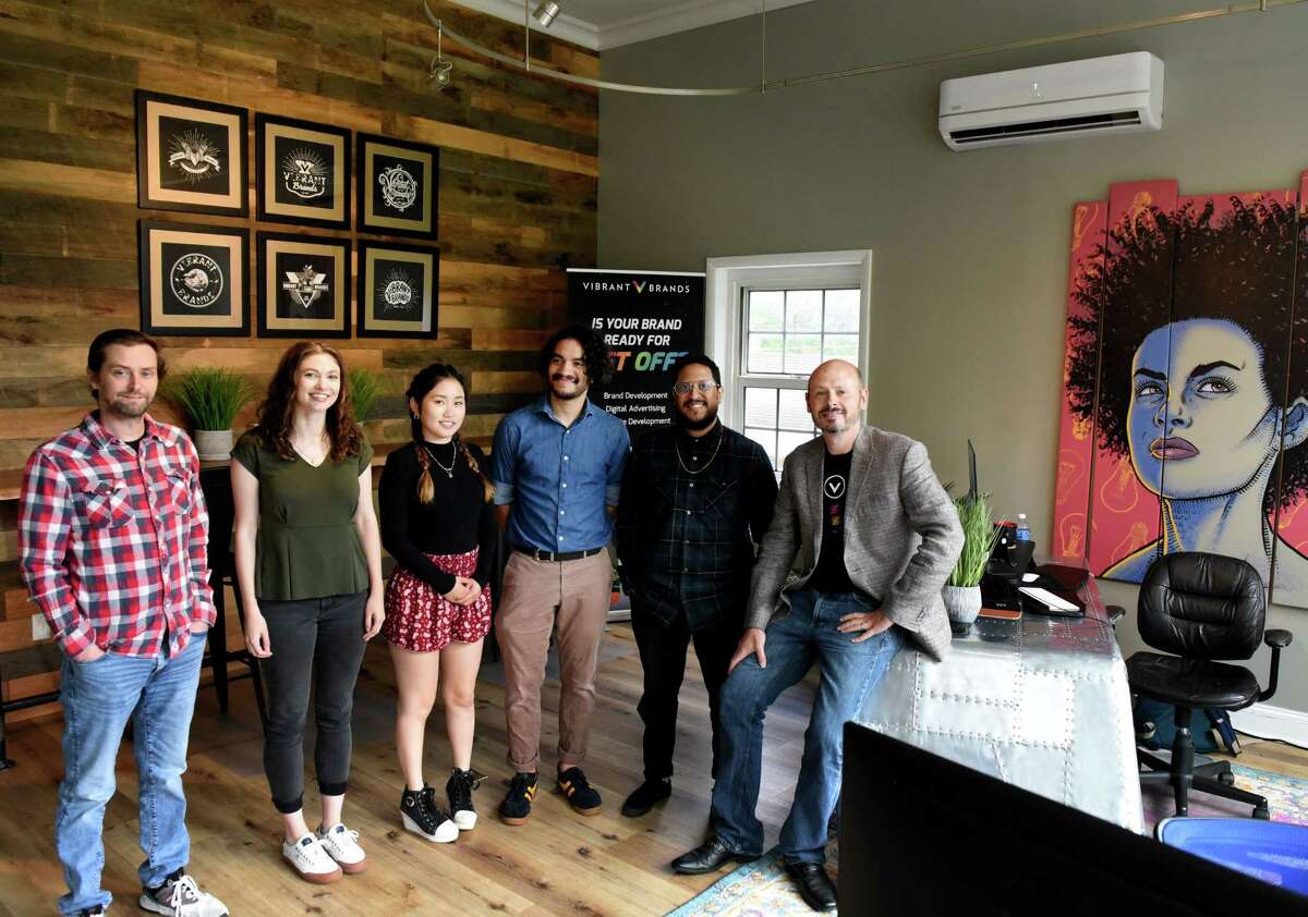 Chris Quereau, owner and CEO of Vibrant Brands advertising agency, right, with employees; Bob Zennett, left, Talia Cass, Mateo Carrera, Anne Lin, Phil Ashby on Tuesday, May 17, 2022, at their offices on Loudon Road in Colonie, N.Y.