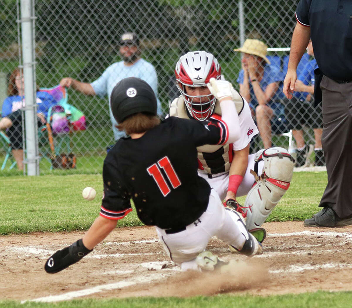 Carlinville catcher Carson Wiser is unable to secure the throw while Bryce Buhs (11) slides in to score a run Thursday in a Class 2A regional semifinal in Gillespie.