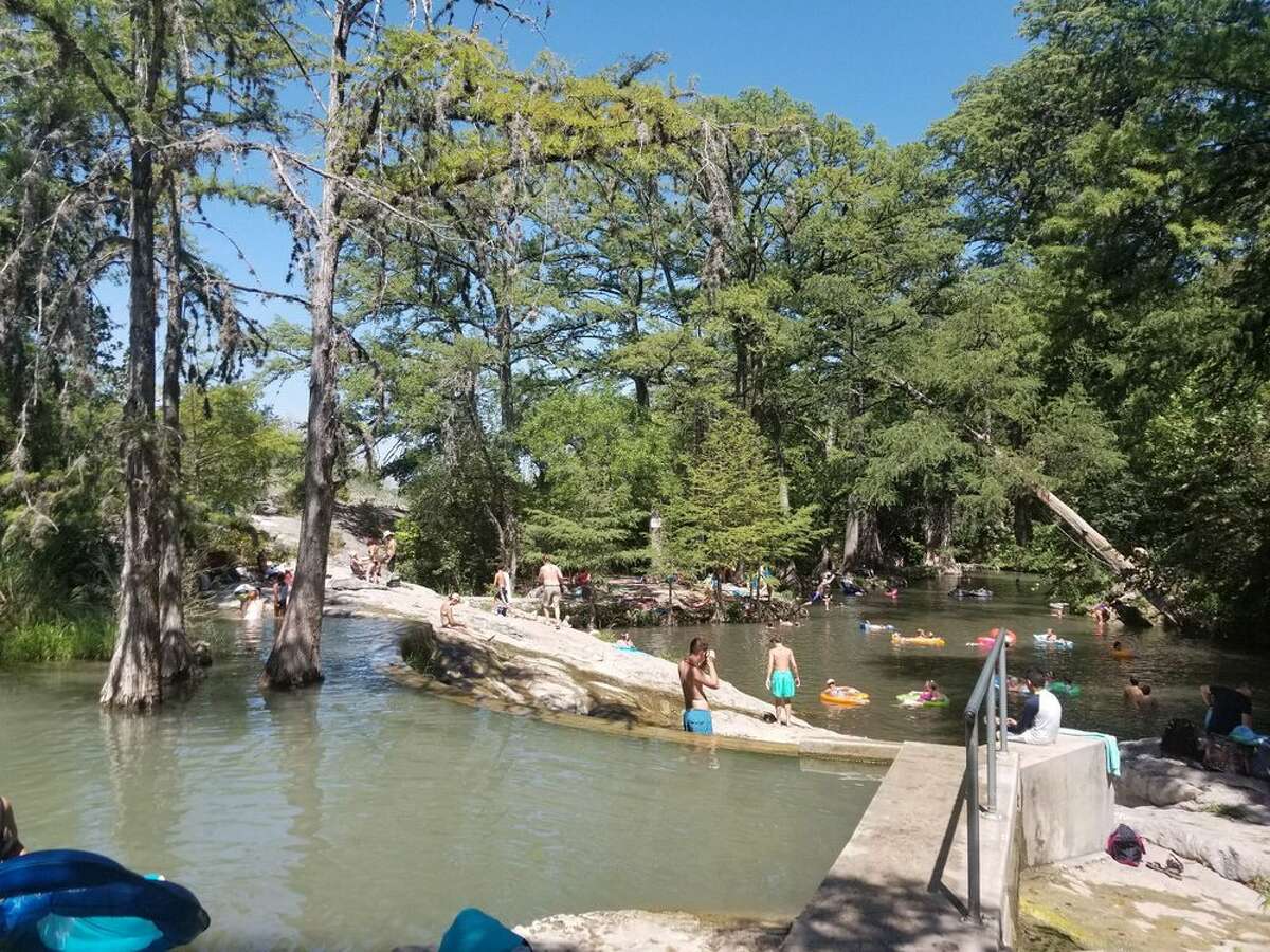 Swimmers enjoy Krause Springs on a hot day.