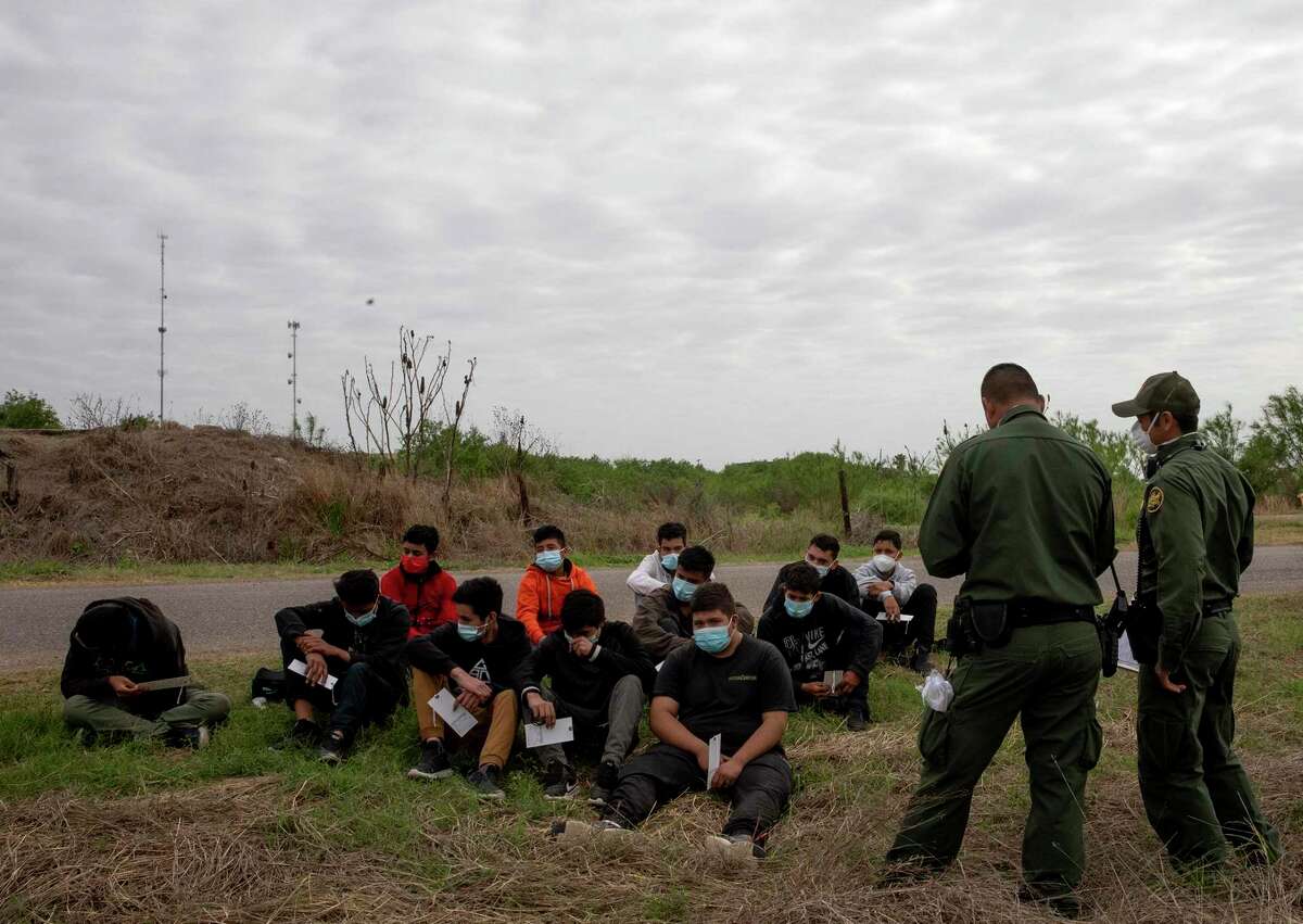 A group of unaccompanied minors wait to be taken in for processing by Border Patrol on April 2, 2021. Border Patrol found the migrants near La Joya, Texas.
