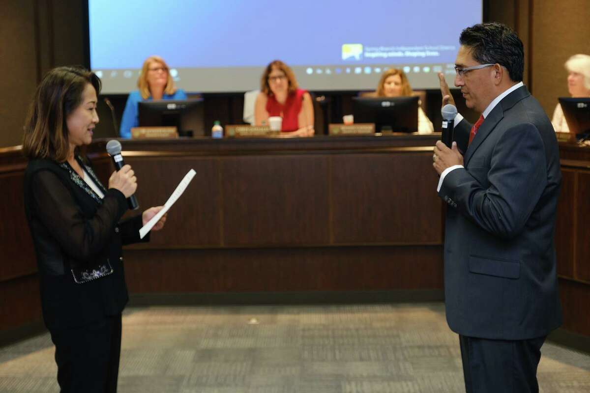 Spring Branch ISD executive assistant to the Board of Trustees Stacy Kim swears in newly elected Position 6 trustee John Perez during a Board meeting on May 17.