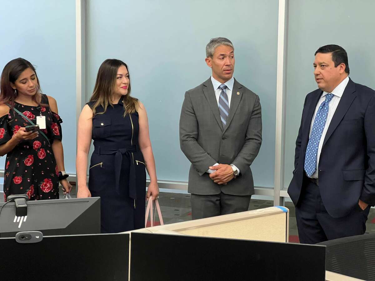 Spectrum Vice President of Customer Service Rene Garcia (right) tells Mayor Ron Nirenberg and Hispanic Chamber of Commerce CEO Marina Gonzales (left of Nierenberg) about what employees do at the facility. 