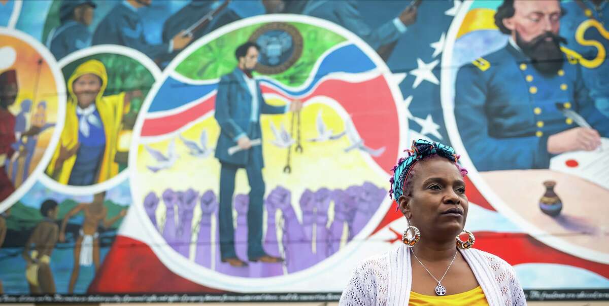 Community activist Roxy Hall Williamson at a new mural commemorating Juneteenth in Galveston on April 4. Last November, a white Republican majority on the Galveston County’s commissioners court voted to redraw Precinct 3 boundaries, splitting Black and Hispanic voters into majority-white districts.