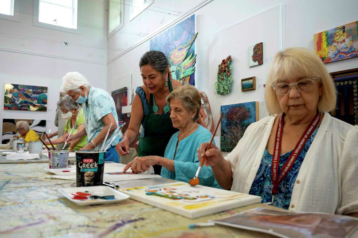 Elizabeth Rodriguez, an art instructor, guides students during an art class at Bihl Haus Arts in San Antonio, Texas, May 4, 2022. The Bihl Haus art studio is dedicated to building relationships within the San Antonio art community and often introduces adult students to established local artists. (U.S. Air Force photo by Airman 1st Class Lauren Cobin)
