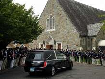The hearse carrying James McGrath arrives at Saint Theresa Church, in Trumbull, Conn. May 20, 2022.