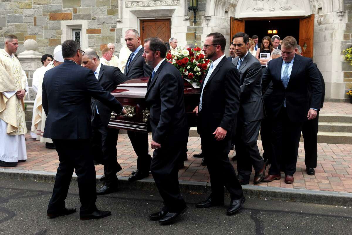 Pallbearers carry James McGrath’s casket out of Saint Theresa Church following his funeral Mass in Trumbull, Conn. May 20, 2022.