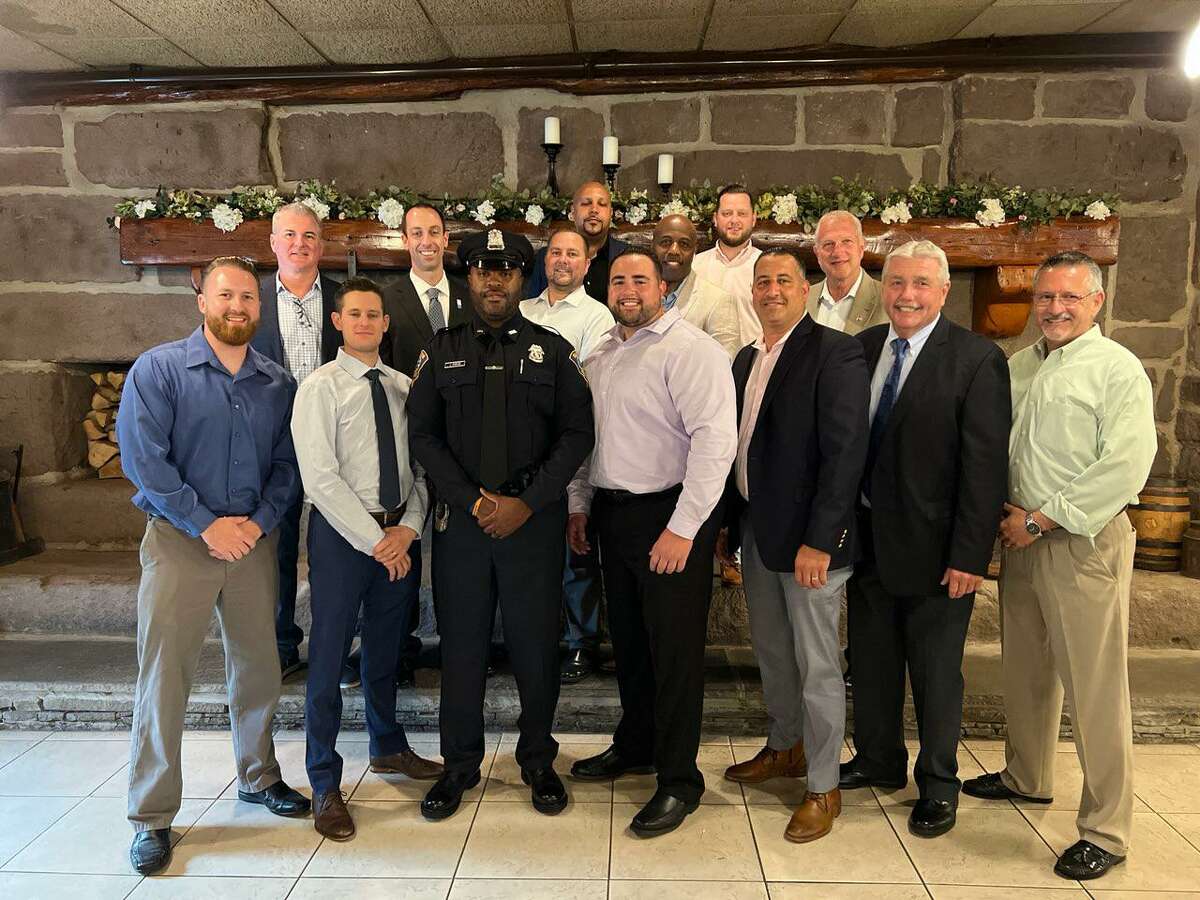 Shelton Police Officer John Staples was named Officer of the Year by the Shelton Exchange Club. Staples received the honor May 20, 2022, at the Aqua Turf in Plantsville while flanked by Mayor Mark Lauretti, Chief Shawn Sequeira and his fellow Shelton police officers.