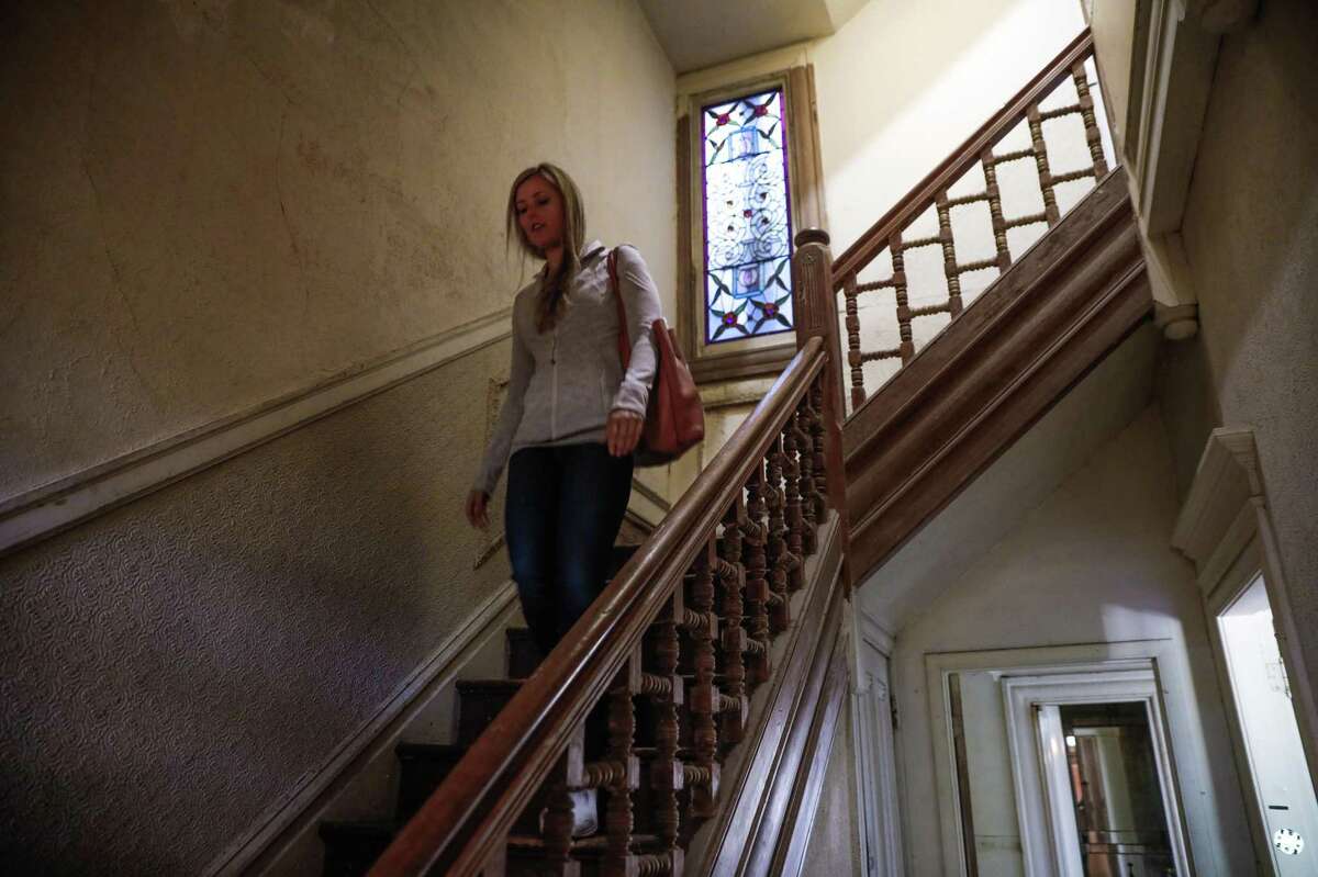 Leah Culver, who has purchased the Pink Painted Lady walks down the stairwell in her newly purchased home on Steiner Street in San Francisco in 2020.