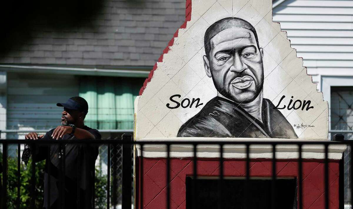 Dennis Glenn stands near a mural of George Floyd at Yates High School as they learn the guilty verdict on all counts in the murder trial of former Minneapolis Officer Derek Chauvin in the death of George Floyd on Tuesday, April 20, 2021, in Houston.