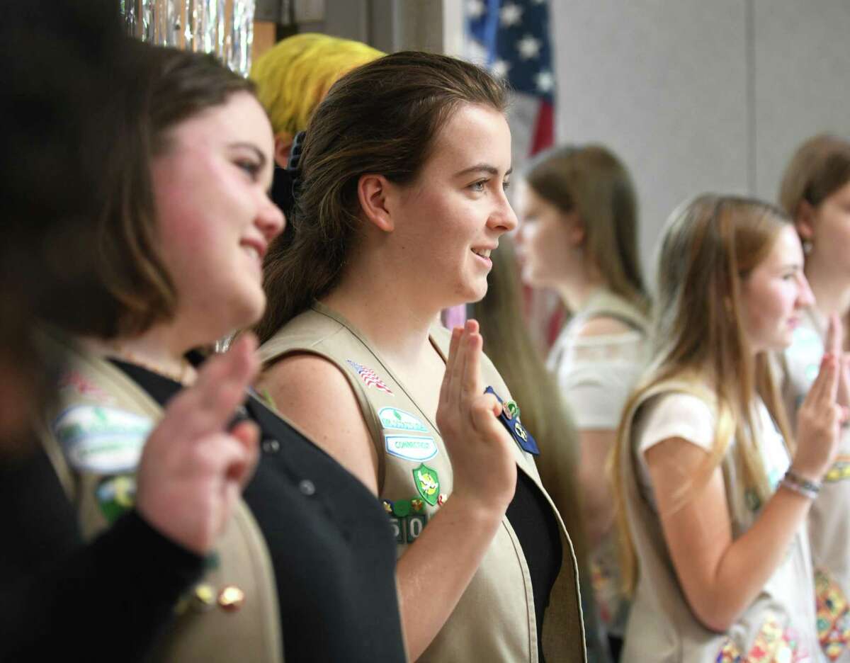 Gold Award recipient Mikaela Browning raises her hand for the Girl Scout Promise during the Greenwich Girl Scouts Service Unit Recognition Ceremony at the YWCA in Greenwich, Conn. Sunday, May 15, 2022. Senior Mikaela Browning, senior Haven Sushon, and junior Mary Kate Blum were awarded the prestigious Gold Award, the highest honor in Girl Scouts.