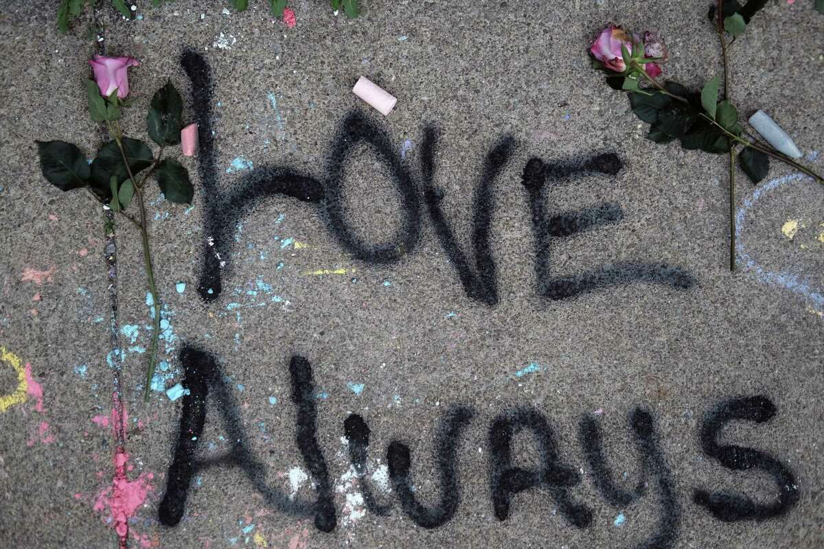 BUFFALO, NEW YORK - MAY 20: Messages on the sidewalk are seen at the memorial for the shooting victims outside of Tops market on May 20, 2022 in Buffalo, New York. 18-year-old Payton Gendron is accused of the mass shooting that killed 10 people at the Tops grocery store on the east side of Buffalo on May 14th and is being investigated as a hate crime. (Photo by Spencer Platt/Getty Images)