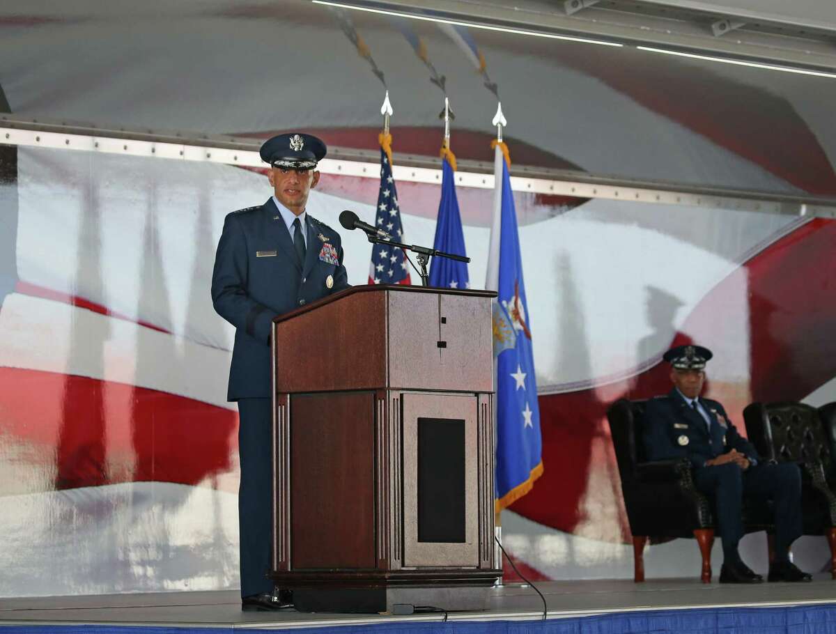 Lt. Gen. Brian Robinson makes remarks after taking command of the Air Education and Training Command from Lt. Gen. Marshall Brad Webb in a ceremony Friday at Joint Base San Antonio-Randolph. Seated at right is Gen. Charles Q. Brown, the Air Force chief of staff.