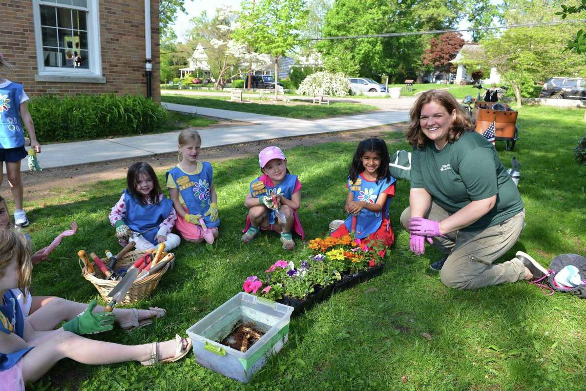 From left, Aoife Horgan, Elodie Kubik, Isabelle Hammer, Norah Lee and Ruby Shah, Daisy level Girl Scouts, learn about gardening on Sunday at Old Greenwich School from Wendy Yu, co-president of the Garden Club of Old Greenwich.