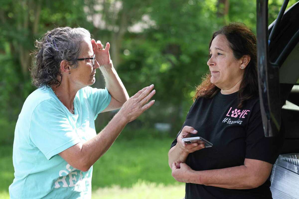 Jane Wesson (left) talks with Anna Barbosa of K911 of Houston Animal rescue about how bad the stray dog population has gotten worse since the pandemic on May 15, 2022 in Houston.